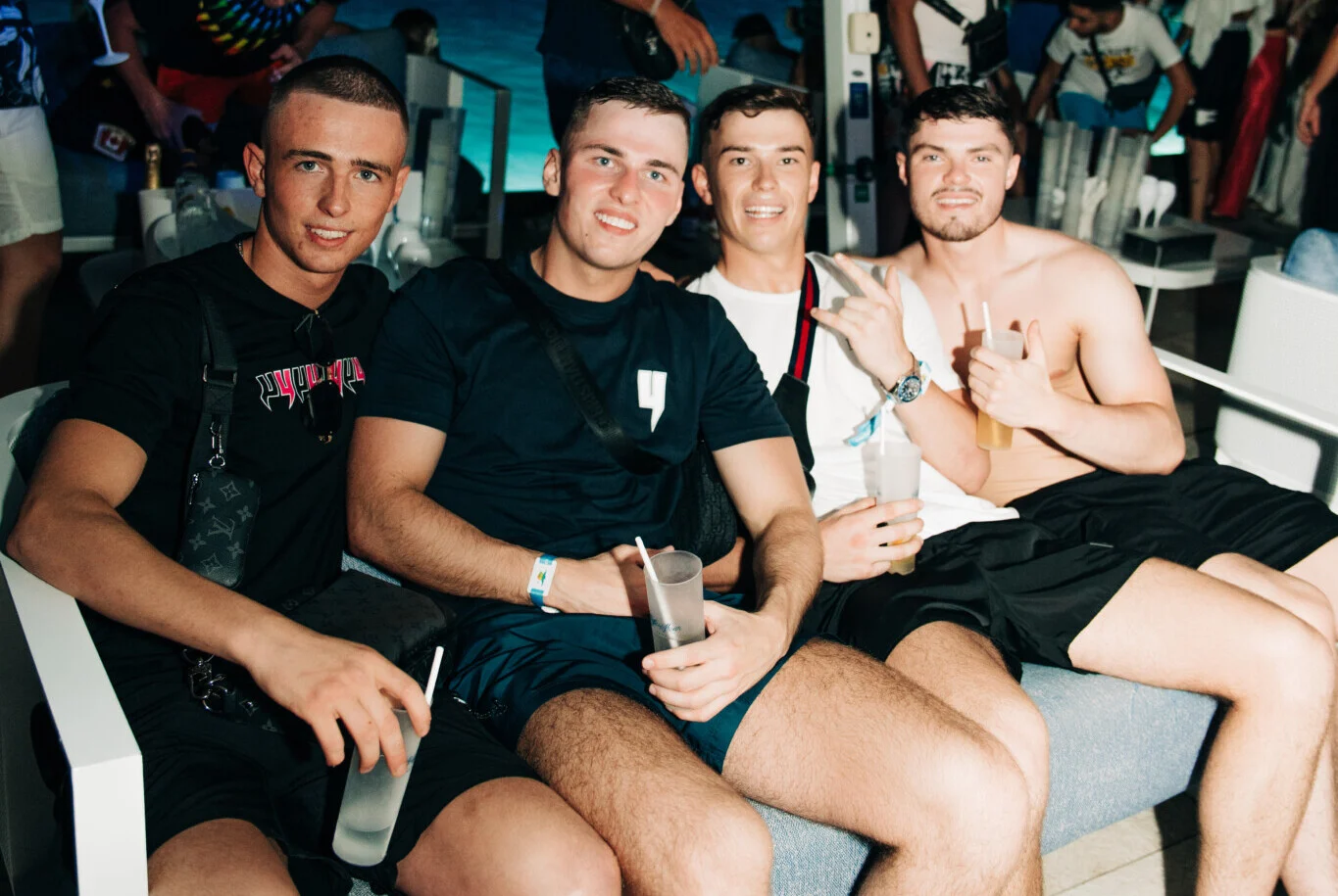 Four lads chilling on sofa seats at Cafe Del Mar Malta, cold drinks in hand and the night warming up fast