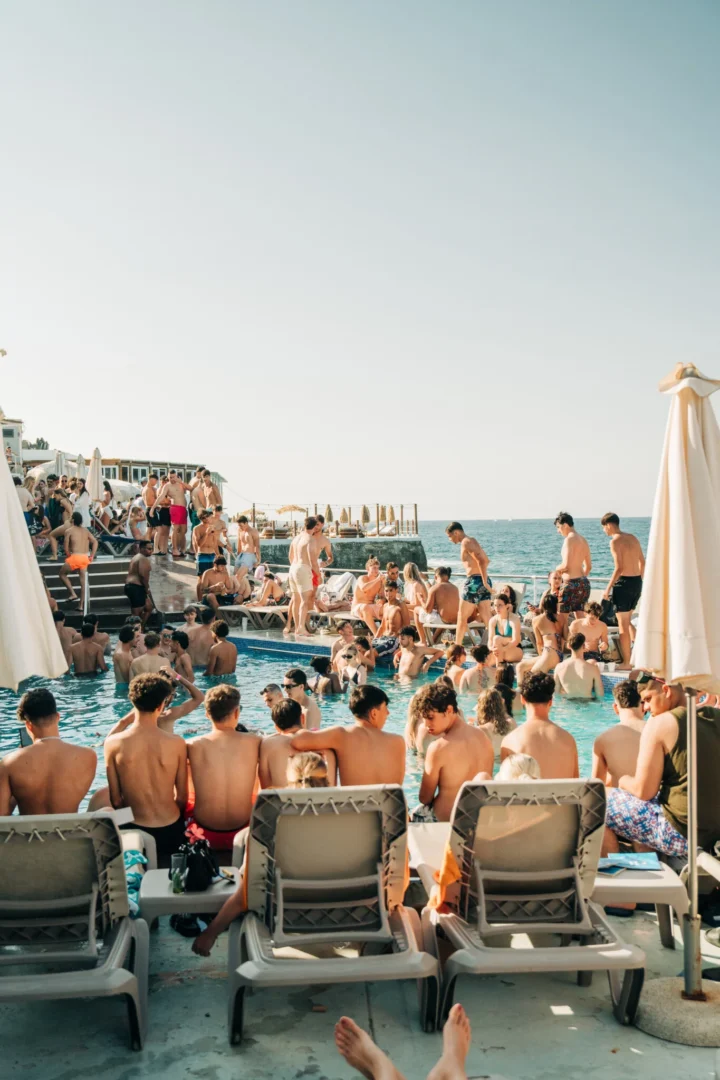 Wide view of the Toy Room Beach Club Party in Malta, with the pool packed, sun loungers full and the sea just beyond the venue.