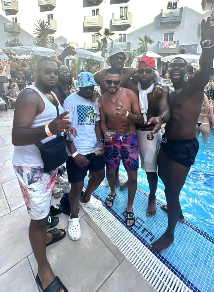 Group of lads posing at Bora Bora Malta pool party with drinks, DJ beats, sunshine and packed daytime party crowds