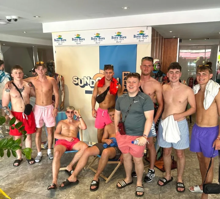 Group of lads posing at Bora Bora Sundown Malta pool party with shorts, drinks and full summer party vibes