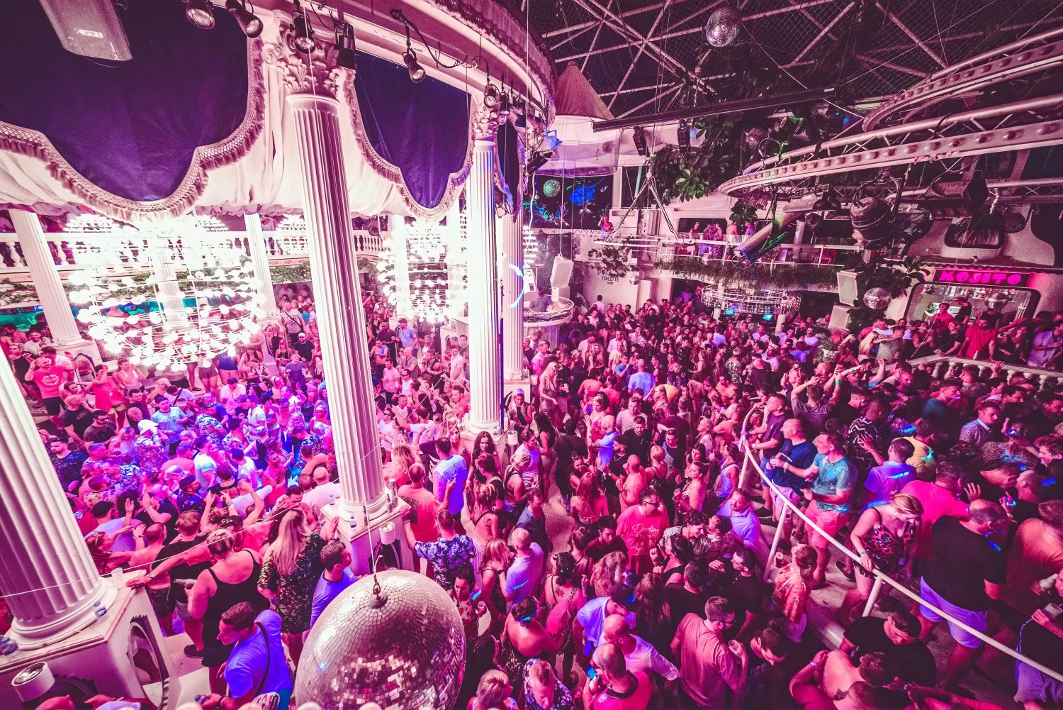 Electric night at Es Paradis Ibiza with packed dancefloors, bright lights and nonstop party energy under the chandeliers.
