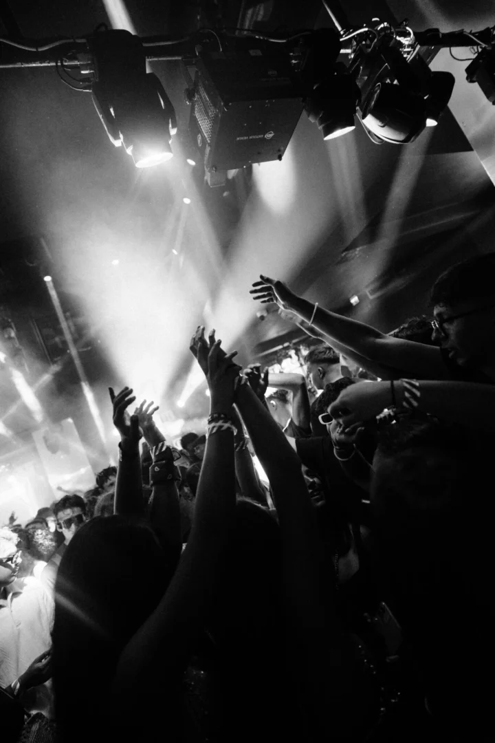 Crowd with hands in the air under bright club lights at Toy Room Super Club in Malta