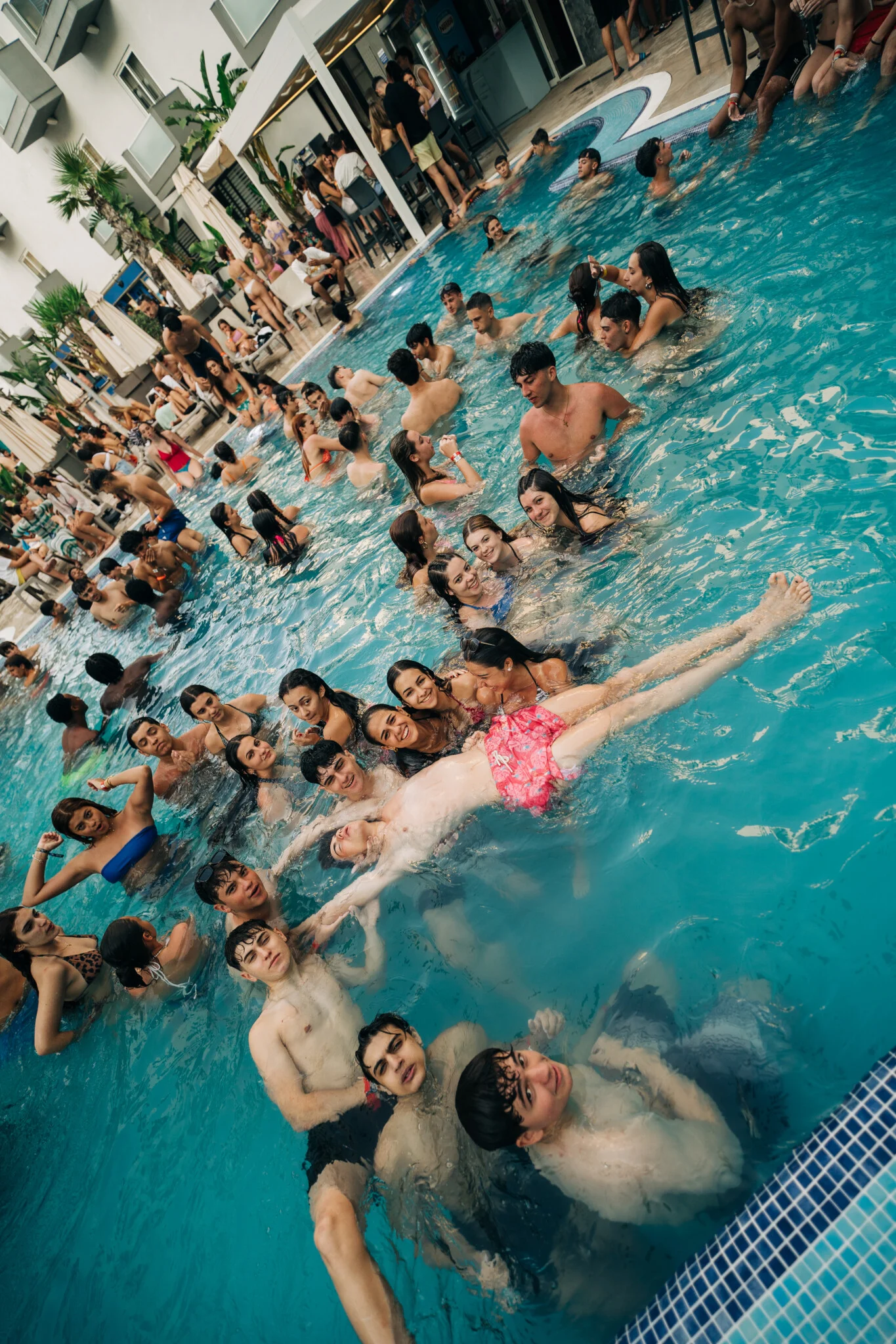 Crowds filling the Bora Bora Malta pool party as lads and girls splash, float and party hard under blue skies and loud DJ sets