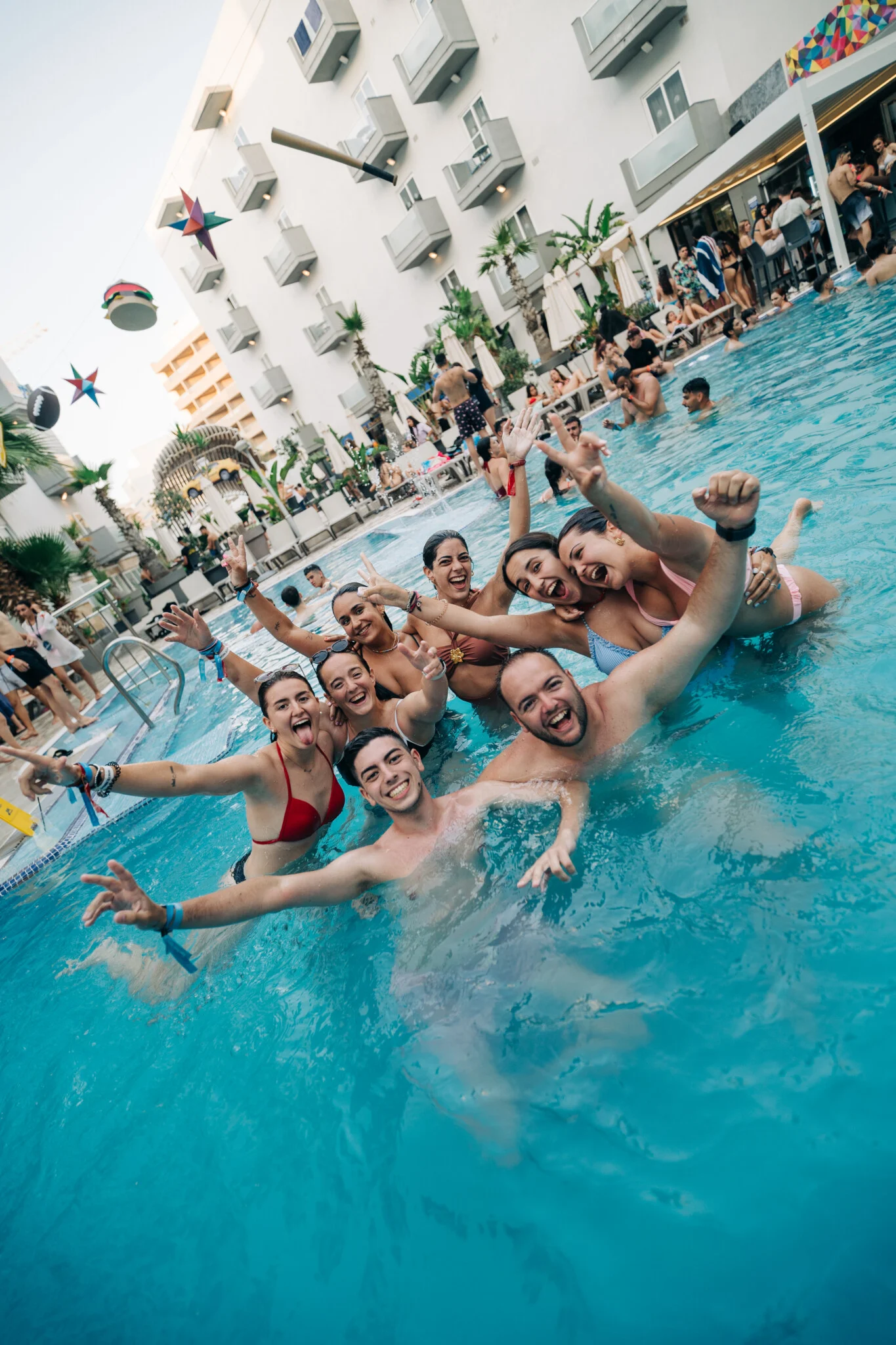 Lads and girls cheering in the Bora Bora Malta pool, arms raised, music pumping and the whole hotel courtyard buzzing with summer energy