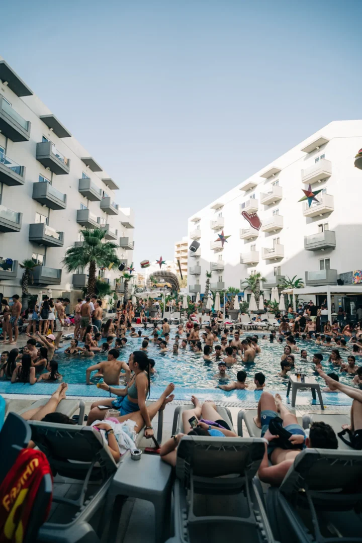 Packed Bora Bora Malta pool party courtyard with sunbeds, DJs, floating drinks and hundreds of partygoers soaking up all day pool chaos