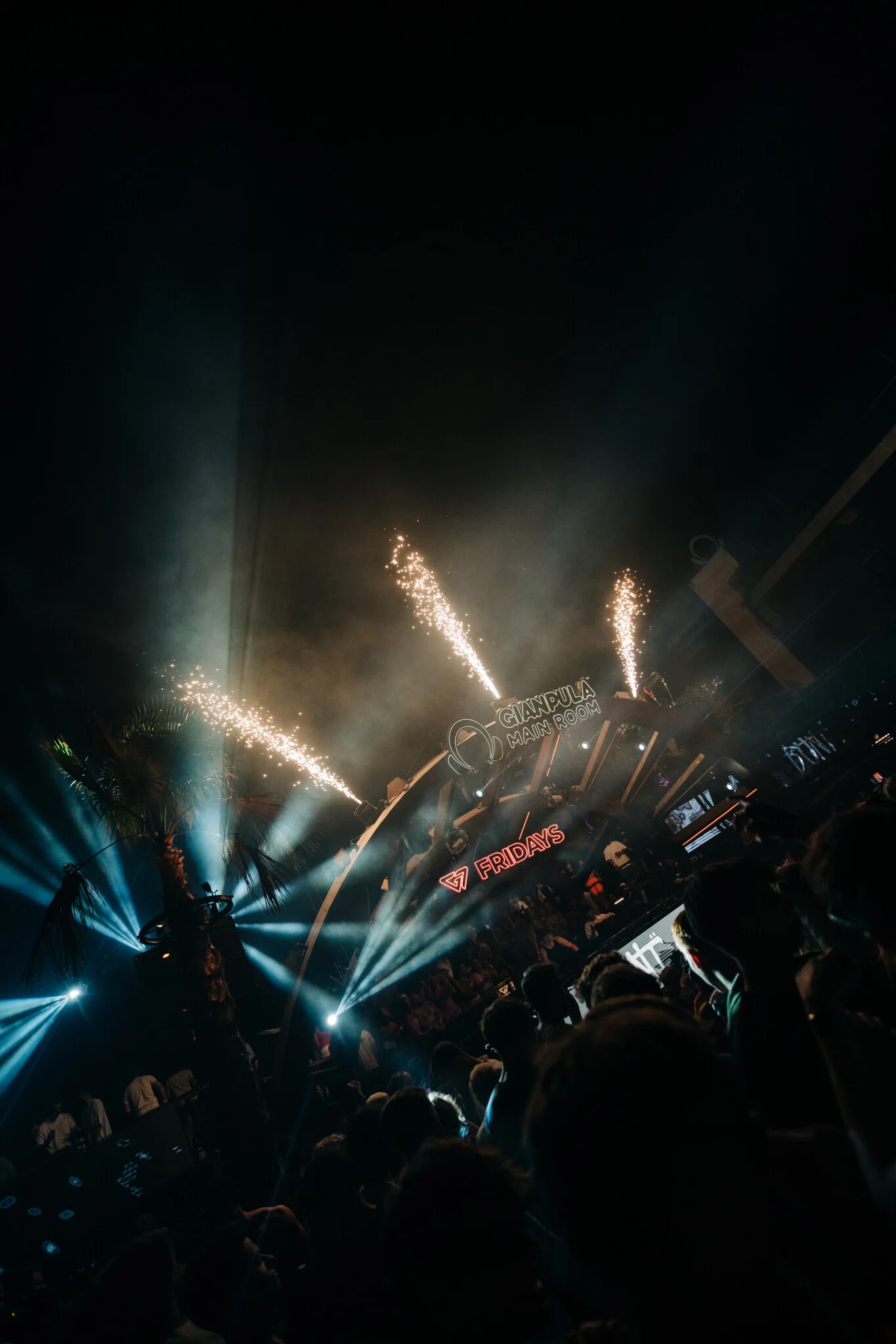 Stage lights and fireworks at Gianpula Fridays Club Night in Malta, with the crowd gathered below at the open-air venue.