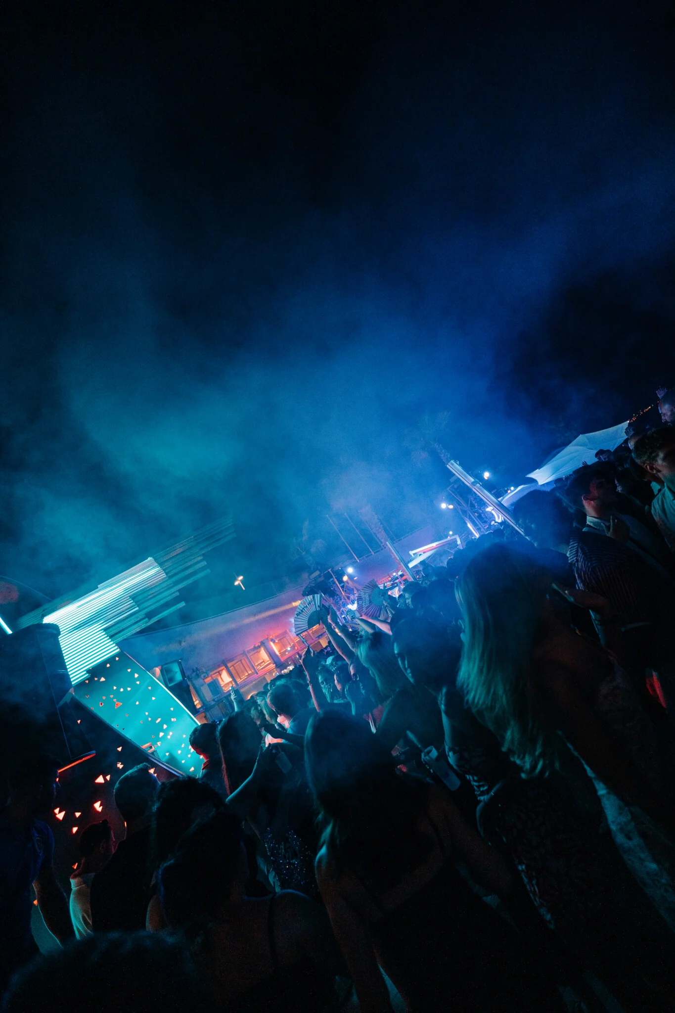 Electric night crowd flooding Cafe Del Mar Malta as laser lights cut through smoke and the open air terrace shakes with bass