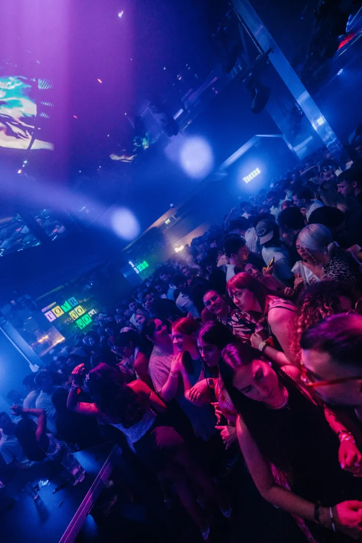 Girls and lads packed across the dancefloor at Toy Room Super Club Night in Malta under pink and blue club lighting