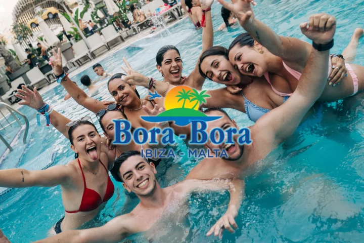 Group of lads and girls cheering in Bora Bora Malta pool party with drinks, sunshine and full summer party energy