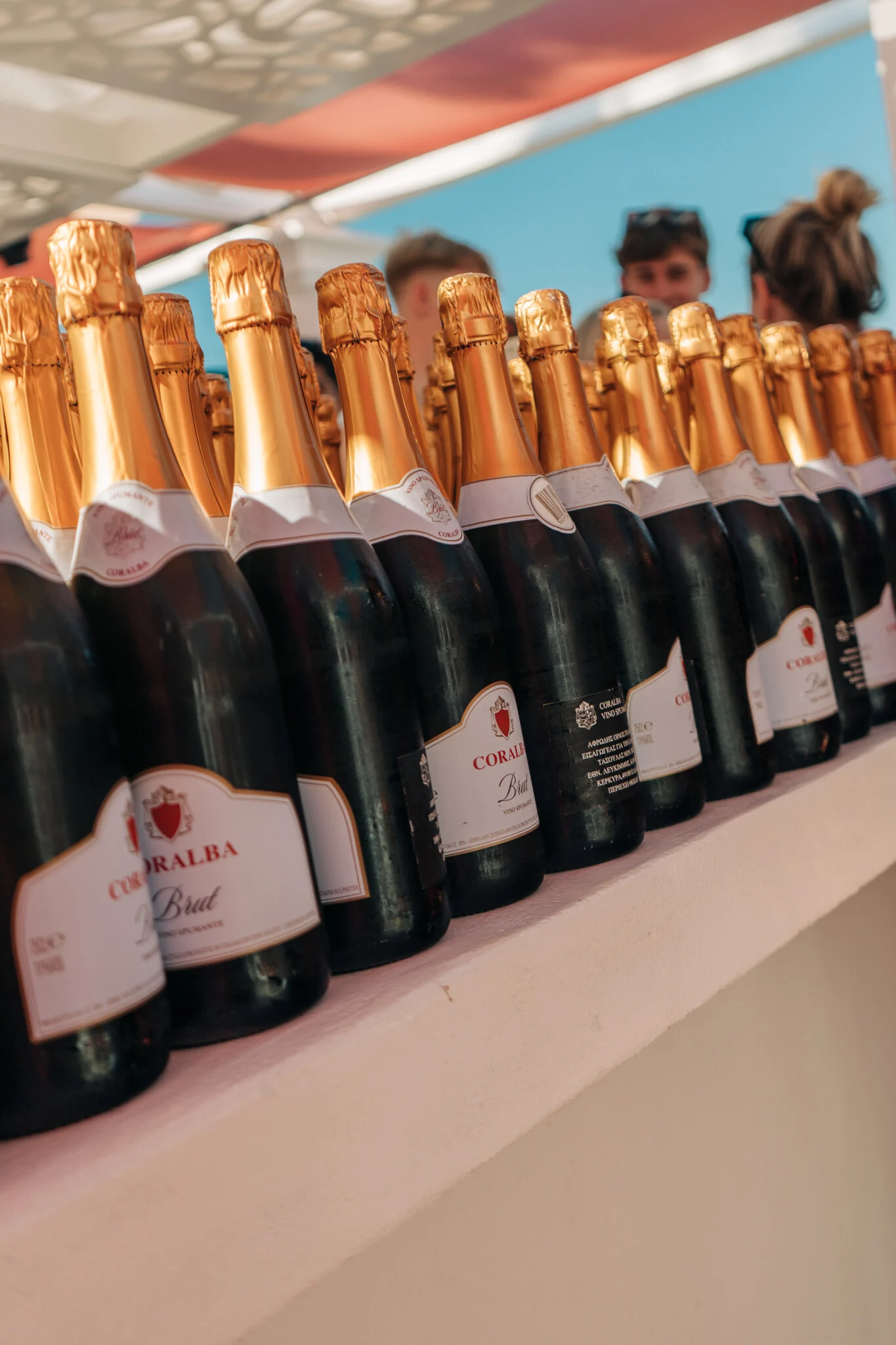 Rows of ice-cold champagne line the bar at Champagne Sessions Kavos, bottles stacked and ready for the pool party rush