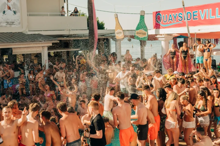Lads and girls erupt as champagne sprays across the pool at Champagne Sessions Kavos, turning the party up