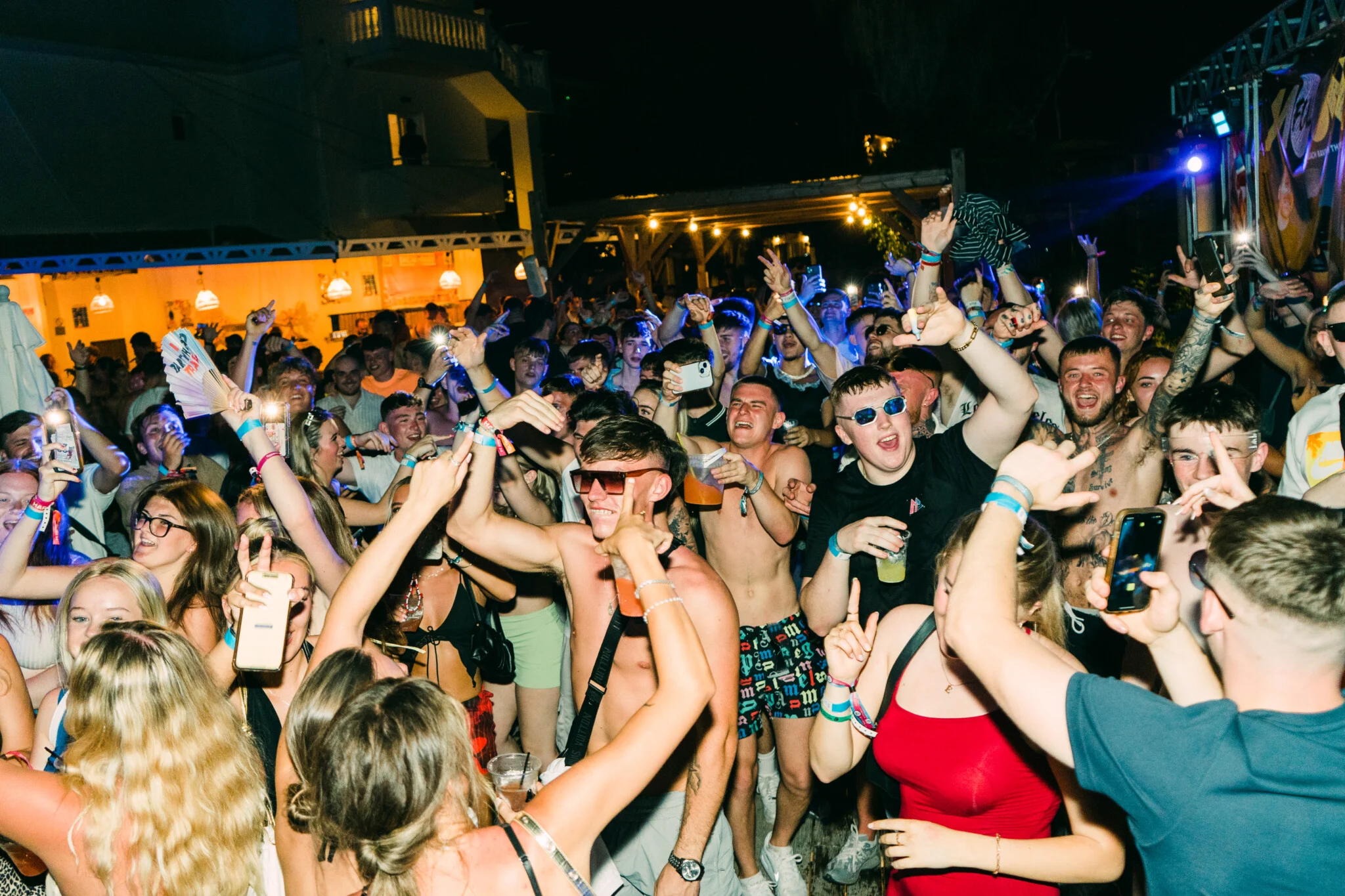 Full Moon Party madness in Kavos as packed crowd jumps, drinks flying, phones up and bass shaking the night