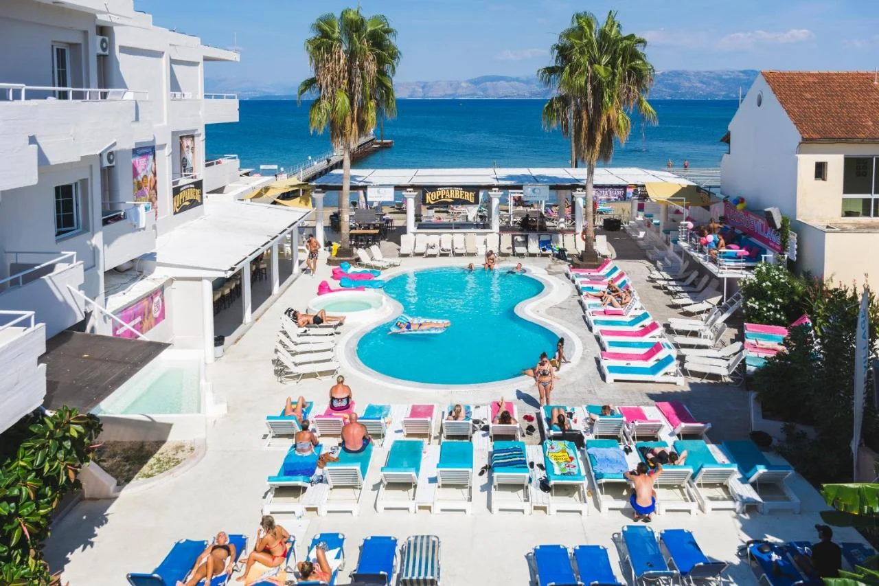 Quayside Village pool party scene with sunbeds, drinks flowing and music pumping by the sea, setting the pace for Kavos days