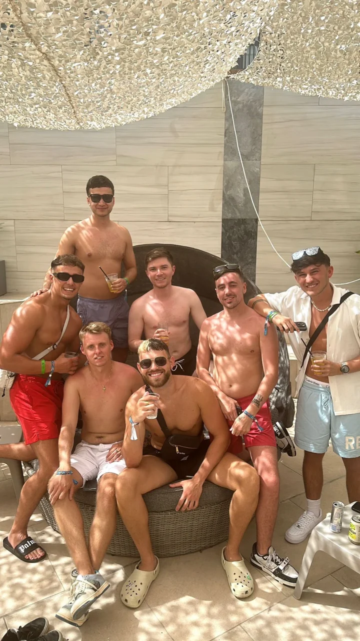Group of lads relaxing at Bora Bora Sundown Malta pool party with drinks, shade seating and full daytime party vibes