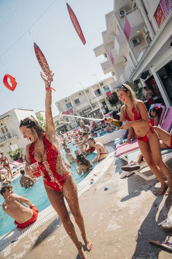 Champagne spraying at Baywatch Pool Party in Kavos as the crowd cools off, drinks in hand and the daytime party hits full throttle