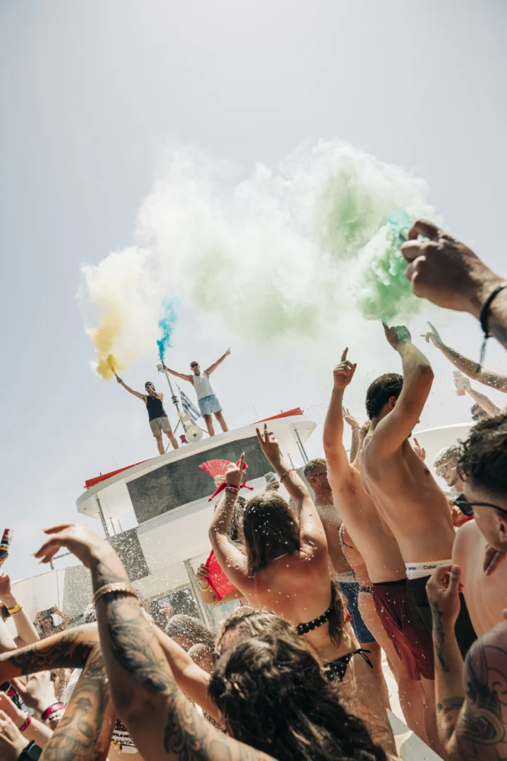 Lads and girls party hard on the Kavos Booze Cruise as coloured smoke fills the sky and the deck erupts