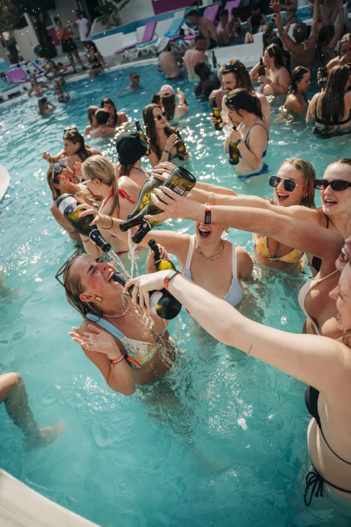Girls pour champagne into their mate’s mouth as the packed pool erupts at Champagne Sessions Kavos, pure daytime chaos