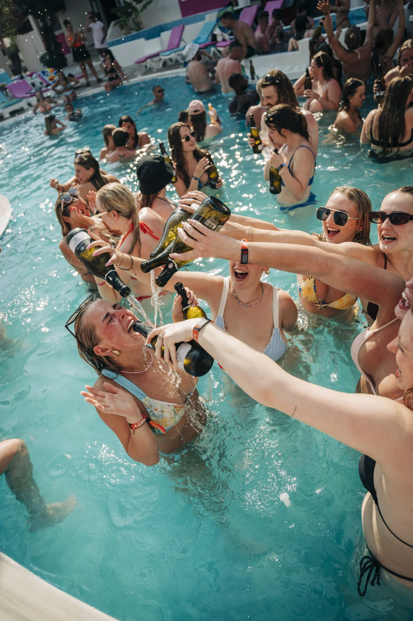 Girls pour champagne into their mate’s mouth as the packed pool erupts at Champagne Sessions Kavos, pure daytime chaos