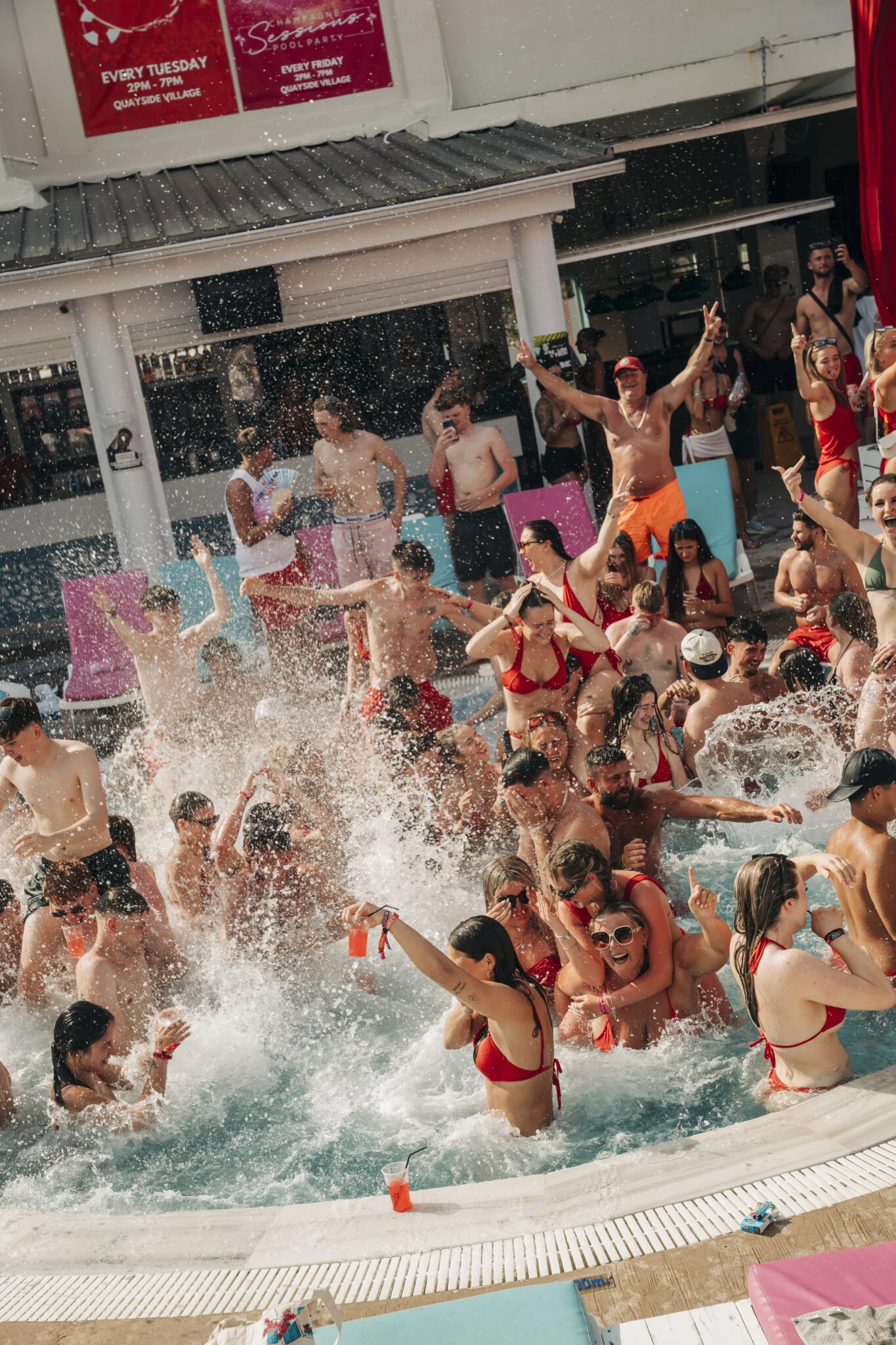 Crowd going wild in the pool at Baywatch Pool Party, Kavos as drinks flow, music pumps and the daytime party hits full throttle