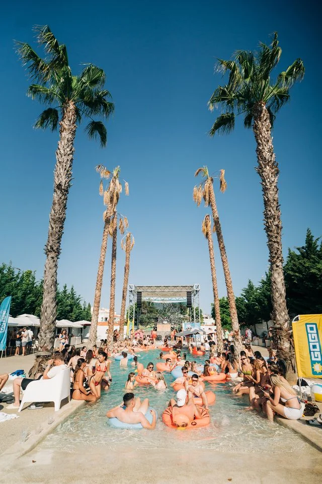 Pool packed with inflatables, drinks and party vibes under the palm trees at the Albufeira Pool Party.