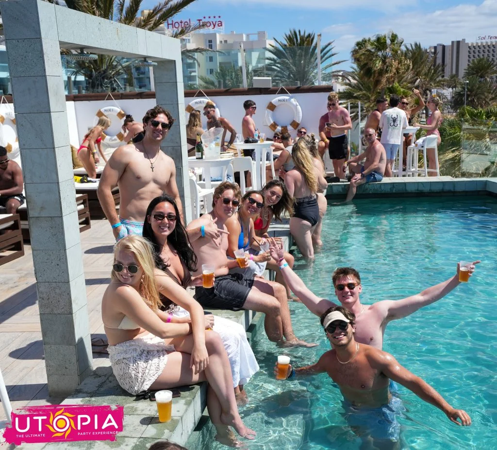 Crowd partying at a Rooftop Pool Party Tenerife with beers in the pool, sunshine vibes and “UTOPIA – The Ultimate Party Experience” text