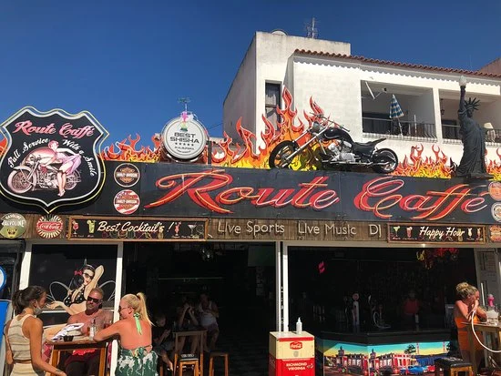 Route 66, an American-style diner and bar in Albufeira, with vibrant signage, a motorcycle display, and outdoor seating.