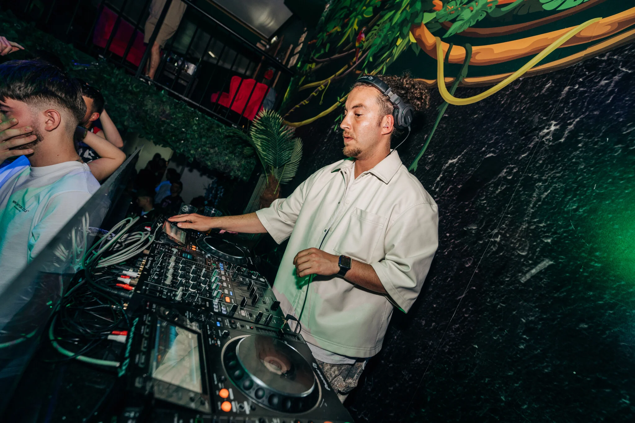 DJ performing in an Albufeira club, crowd buzzing, beats dropping and party vibes taking over the dancefloor.