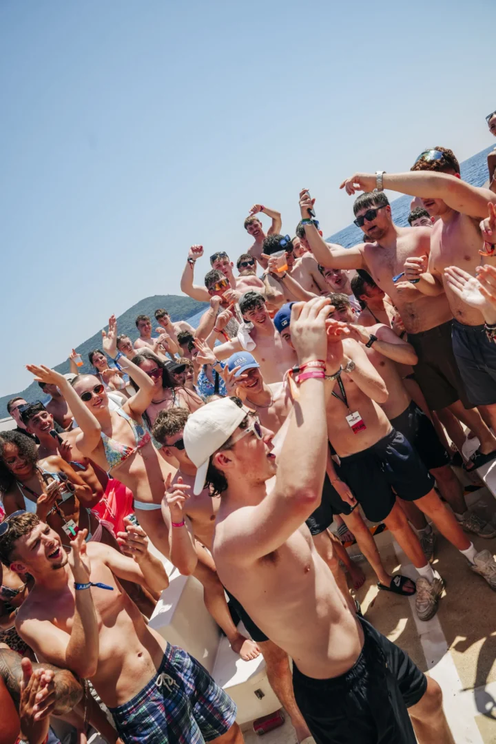 Kavos boat party in full swing as the crowd packs the deck, drinks up, hands in the air and pure daytime chaos kicks off