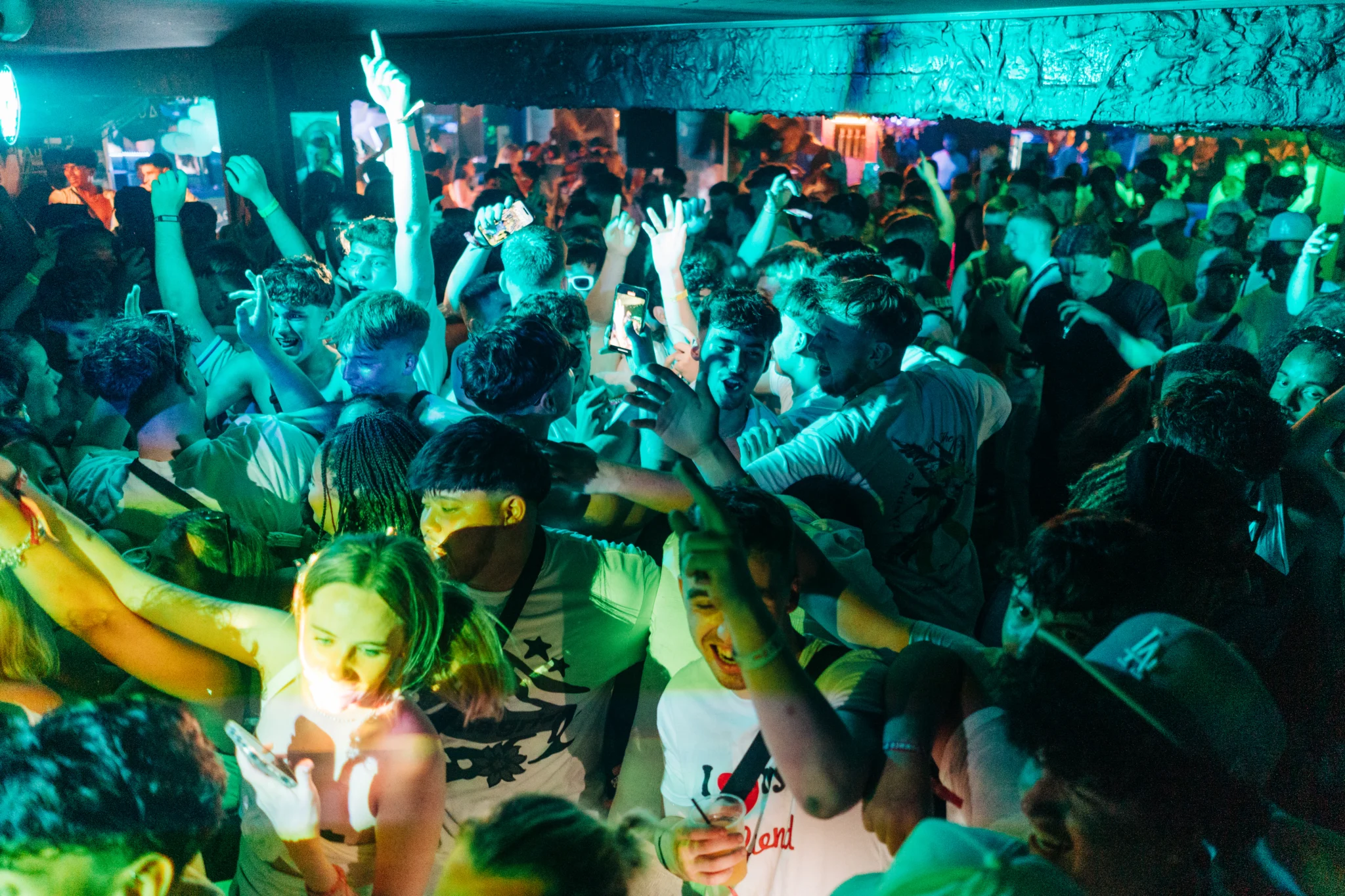 Packed crowd partying at the After Party Pass Croatia event in Bacvice Club Split with phones up, drinks flowing and hands in the air