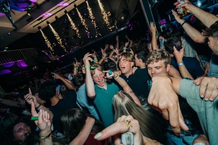 Crowd going wild at the House of Tech event in Albufeira with hands in the air and the dancefloor packed wall to wal
