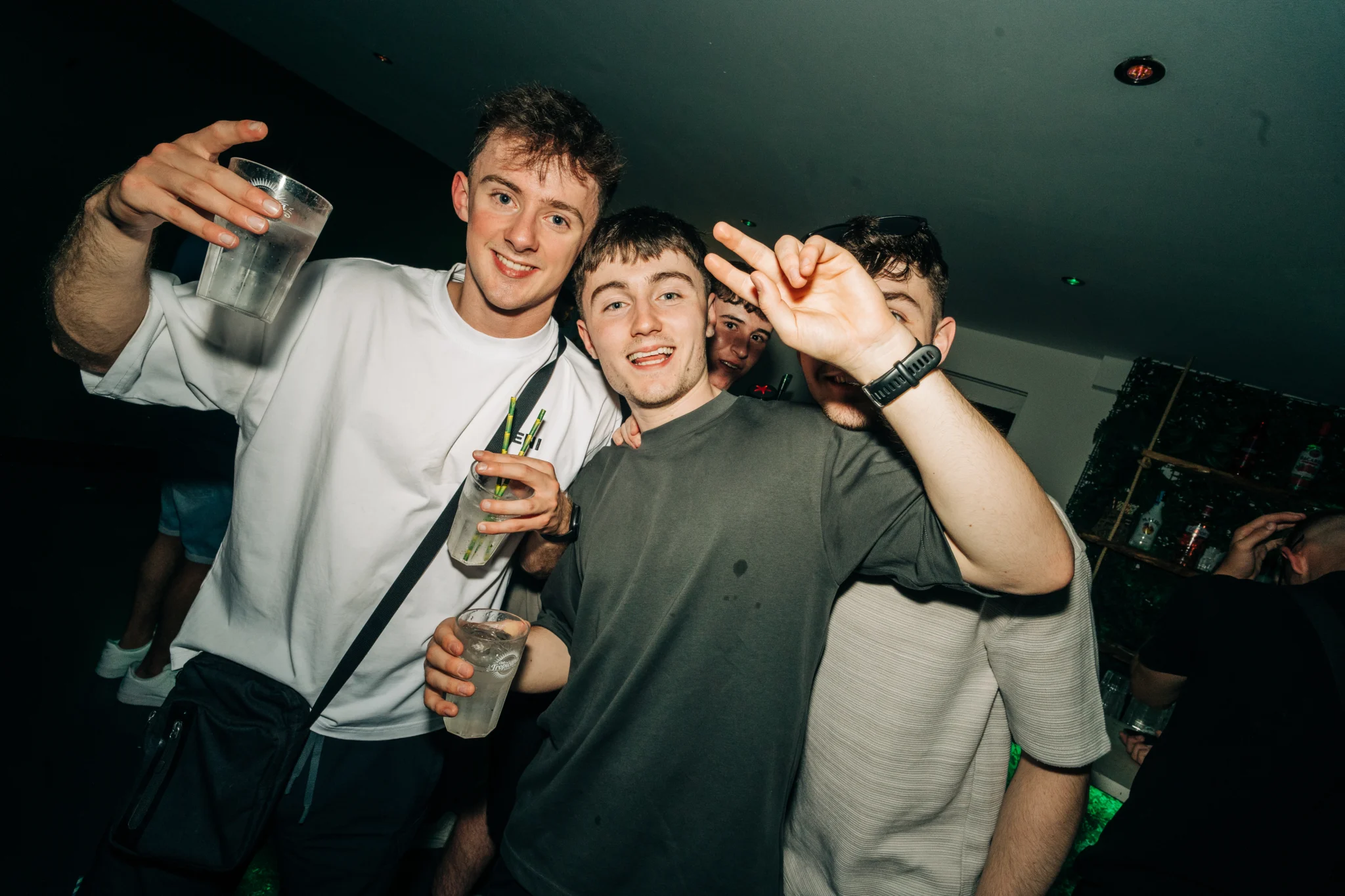 Group of lads posing with drinks at the Love Juice event in Tropicana Night Club Albufeira during a lively night out