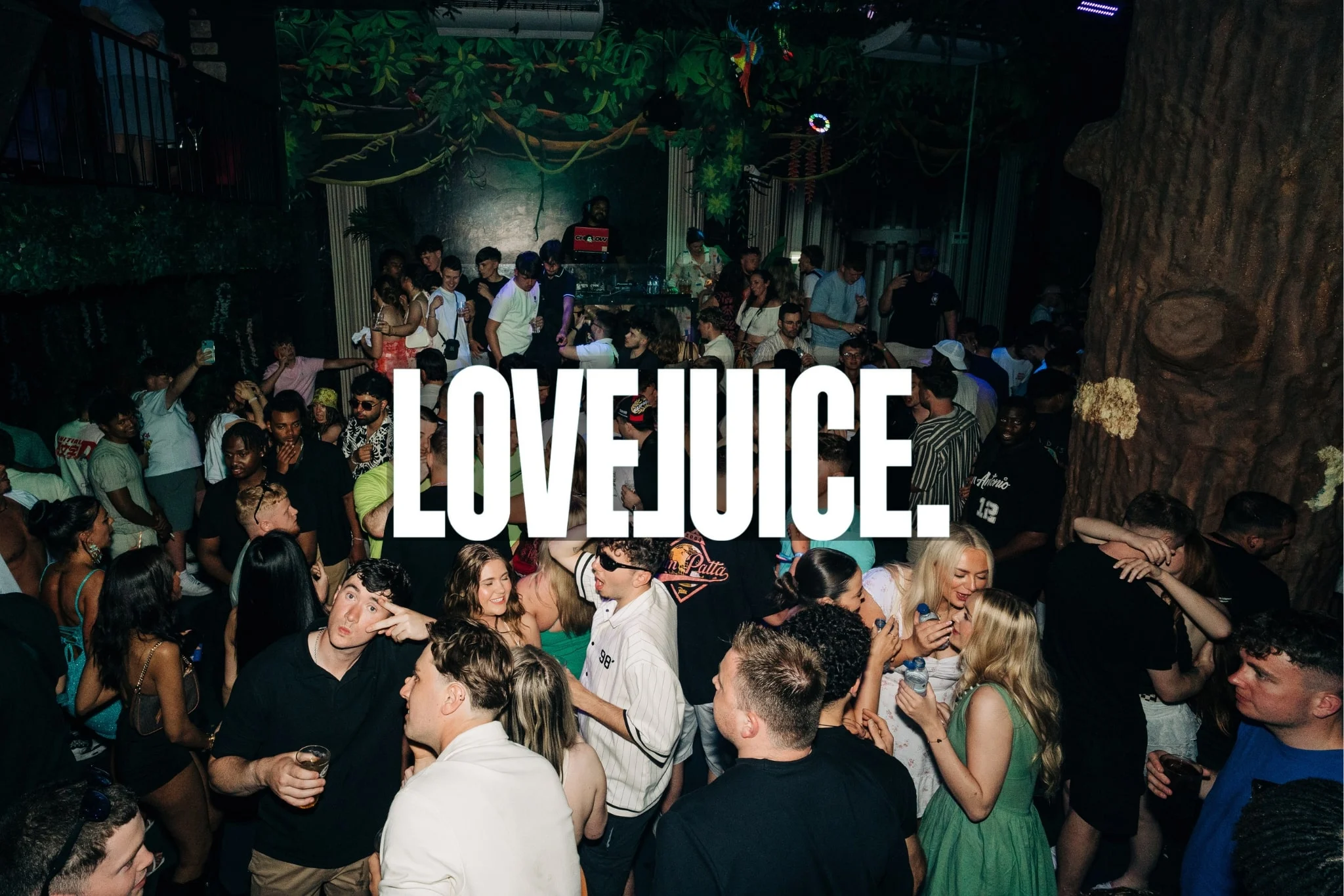 Crowd partying at Love Juice Albufeira in a packed nightclub with DJs, drinks and groups dancing across the venue