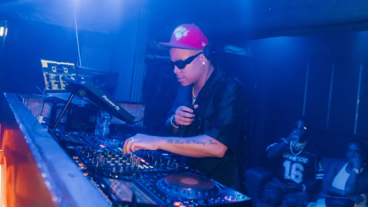 DJ in a pink cap and sunglasses mixing on the decks during the Napa Xtra event at Aqua Club in Ayia Napa