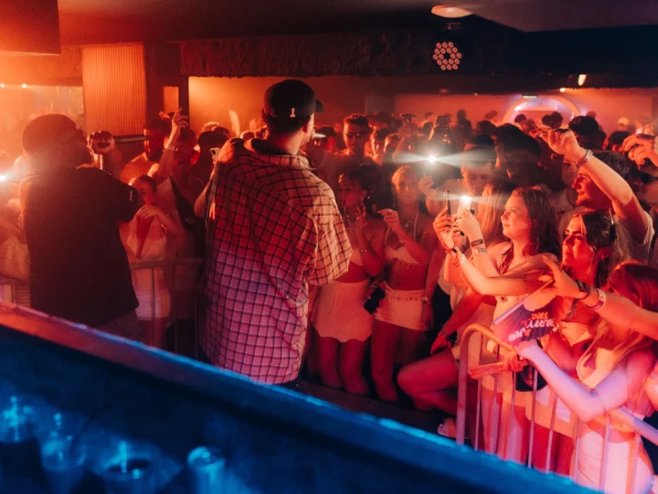 Two MCs performing in front of a packed crowd filming the set at Napa Xtra in Ayia Napa